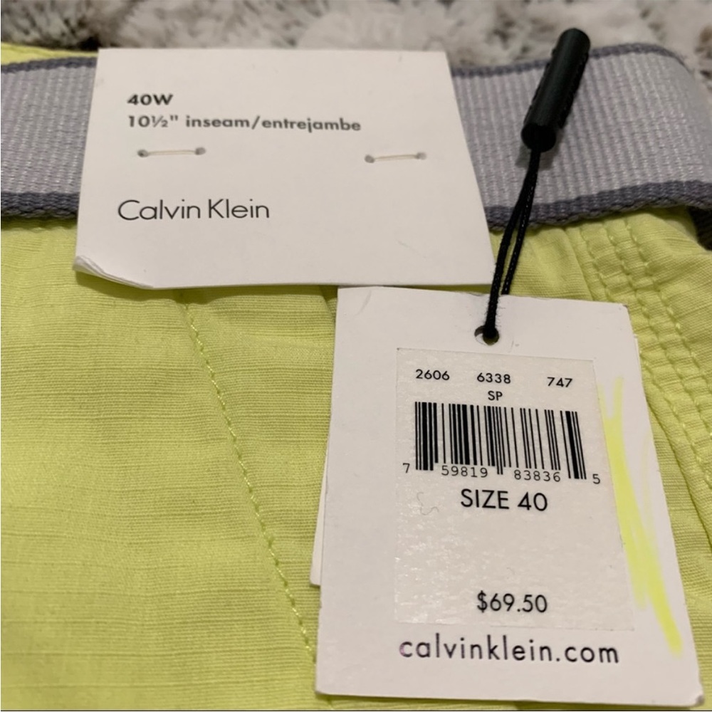 yellow Calvin Klein shorts and belt size 40